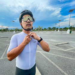 Portrait of young man standing on road