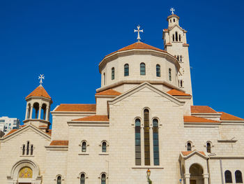 Low angle view of building against clear blue sky