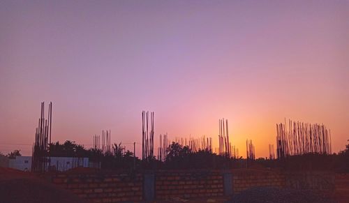 Silhouette buildings against sky during sunset