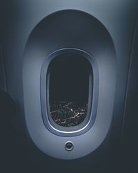 Illuminated cityscape seen through airplane window