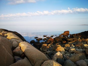 Rocks on beach against sky