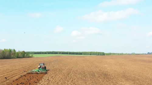 Scenic view of agricultural field against sky