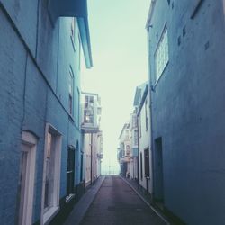 Street amidst residential buildings against sky