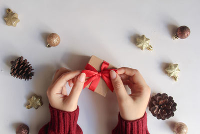 Cropped hands of woman holding christmas decoration