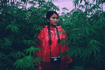 Portrait of girl standing by plants