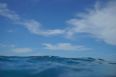 Low angle view of sea against blue sky