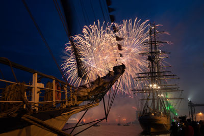 Low angle view of fireworks against sky at night