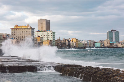 Scenic view of sea and buildings against sky