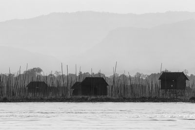 Houses by sea against sky