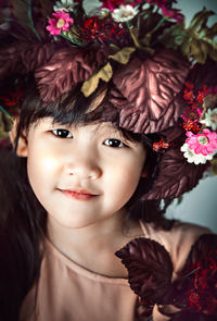 Close-up portrait of cute girl wearing flowers