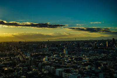 High angle view of illuminated cityscape against sky during sunset