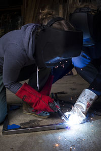 Rear view of man working at workshop