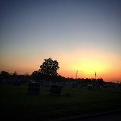 Scenic view of field against sky at sunset