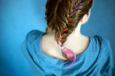 Generation z girl hairstyle on blue background. colorful hair