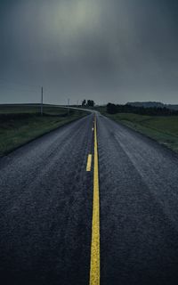 Road passing through land against sky