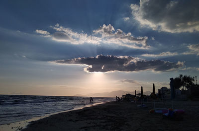 Panoramic view of beach against sky during sunset