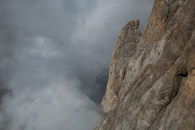 Low angle view of rock formation against sky