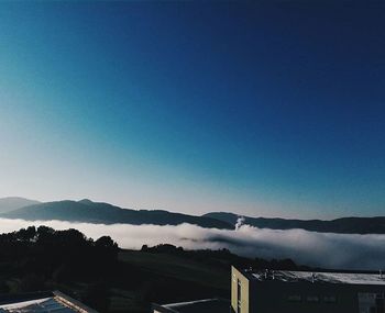 Scenic view of mountains against blue sky