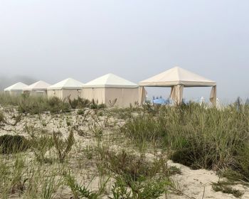 Built structure on beach against clear sky