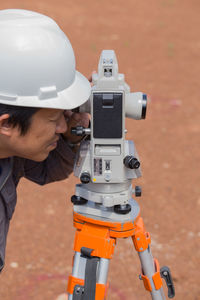 Close-up of surveyor working outdoors