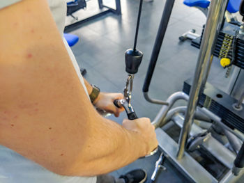 Midsection of man exercising in gym