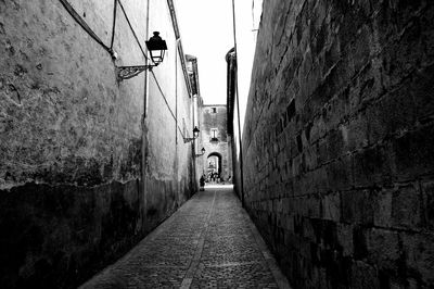 Alley amidst buildings against sky