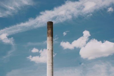 Low angle view of smoke stack against sky