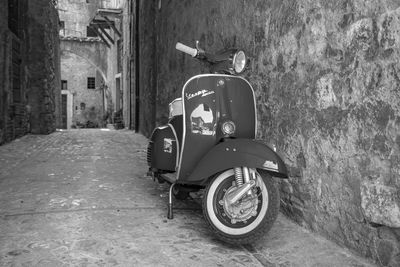 Motorcycle on street amidst buildings in city