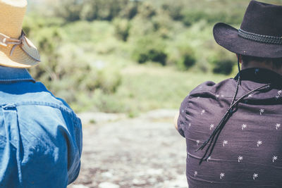 Low section of man wearing hat standing on land