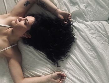 High angle view of woman lying on bed