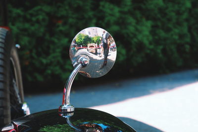 Close-up of coin-operated binoculars against trees