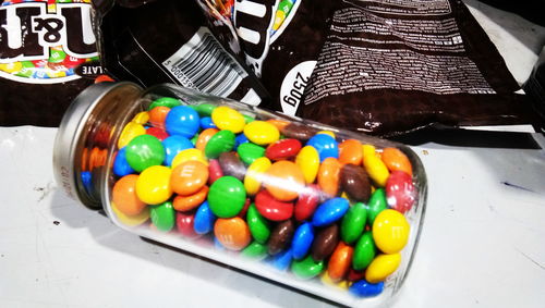 High angle view of multi colored candies in container