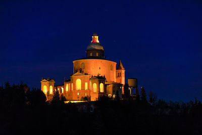 Illuminated building against sky at night