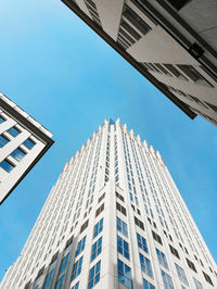 Low angle view of modern building against clear blue sky