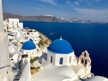 Panoramic view of sea and buildings against sky