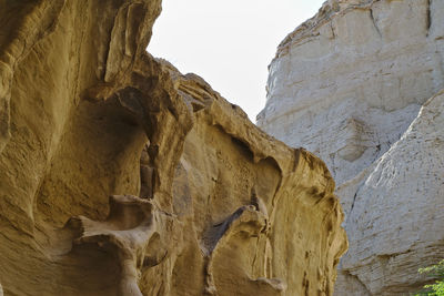 Low angle view of rock formation against sky