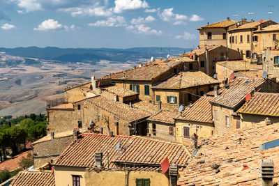 High angle view of buildings in town against sky