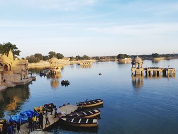 High angle view of boats moored in lake against sky