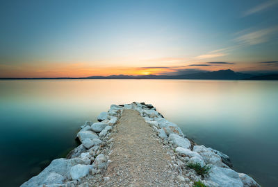 Scenic view of lake against sky during sunset