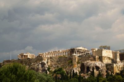 Buildings against cloudy sky