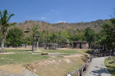 Built structure on field against trees