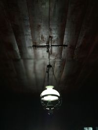 Low angle view of illuminated pendant light hanging from ceiling