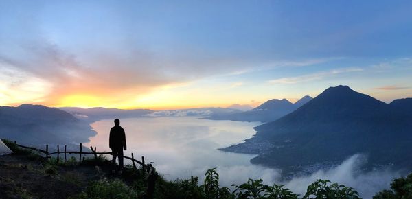 Girl during sunrise at indian nose in lake atitlan 