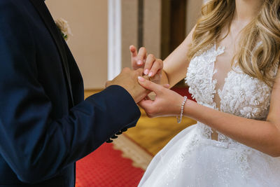 Midsection of couple holding hands