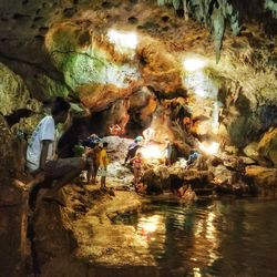 Group of people on rock in cave