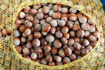 Directly above shot of chestnuts in basket at market