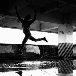 Full length of man jumping on water