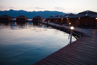 View of swimming pool by lake against sky