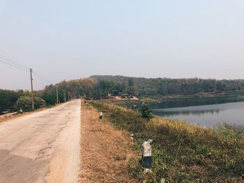 Rear view of person on road against clear sky