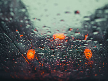 Close-up of wet glass window during rainy season